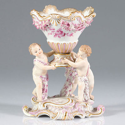 Meissen porcelain characters supporting a 19th mark cup with crossed swords
