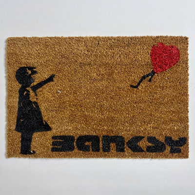 Banksy. “Girl with balloon”. Stencil painted doormat.