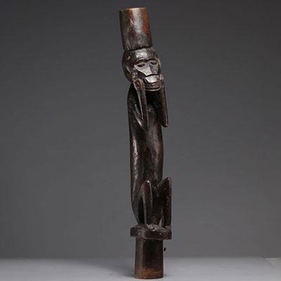 Post carved with a dark patina monkey