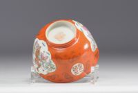 China - An orange porcelain bowl decorated with figures and bats, 19th century.