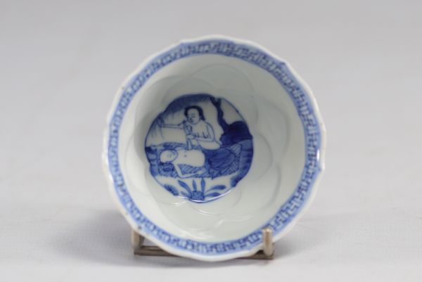 China - A white and blue porcelain bowl decorated with a medical scene, 18th century.