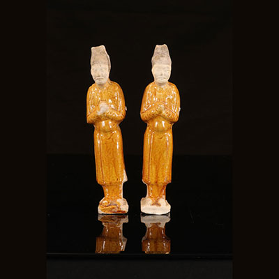 Pair of amber glazed attendants