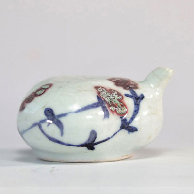 Porcelain teapot in the shape of a fruit decorated with flaming flowers