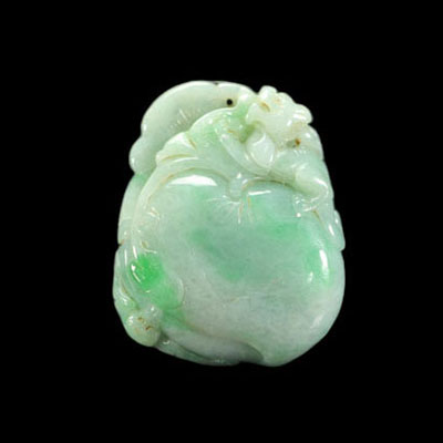 Jade carved with a peach topped with a bat in the colours of light green and green apple