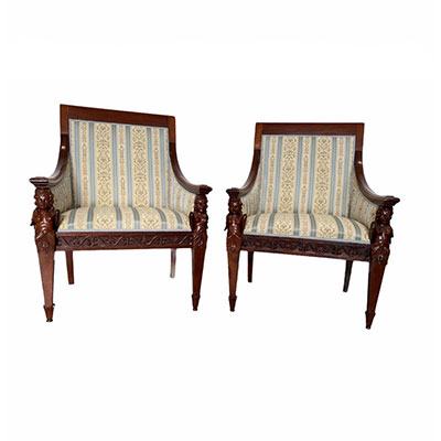 Pair of richly carved mahogany armchairs, armrests decorated with 19th century angels' heads