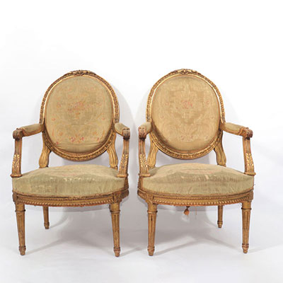 Pair of Louis XVI period armchairs in carved and gilded wood with 18th leaf