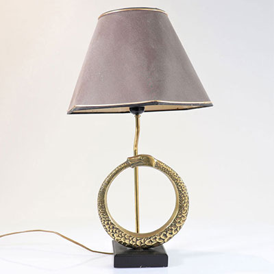 Vintage lamp decorated with a snake biting its tail in bronze