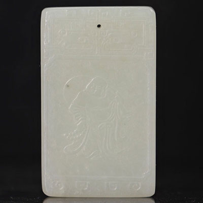 Carved white jade plaque showing 