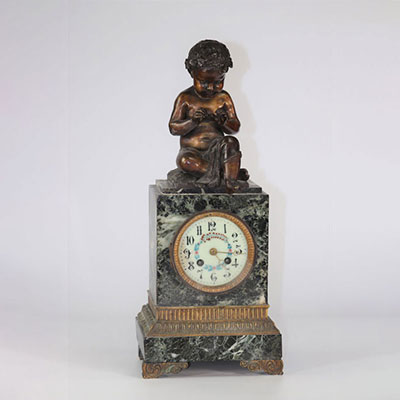 Marble clock surmounted by a bronze child