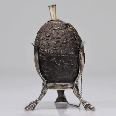 Coconut powder flask sculpted with figures. Silver base