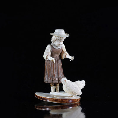 France ivory carved of a young woman feeding a working rooster probably Dieppois 1900