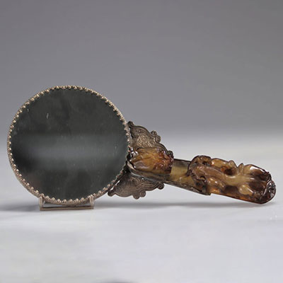 Hand mirror handle formed by a jade fibula