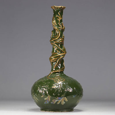A gilded and iridescent earthenware vase on a green background decorated with chimeras from Austria