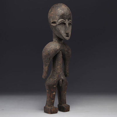 Carved wooden statue and color dots