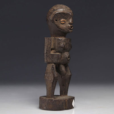 Carved wooden statue, eyes adorned with cowries