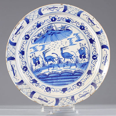 Large 18th century Delft dish decorated with characters and waders