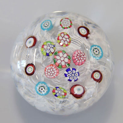 Baccarat paperweight with floral decoration on a 19th century lace background