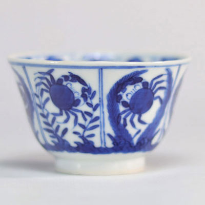 White and blue porcelain bowl decorated with fish and crabs