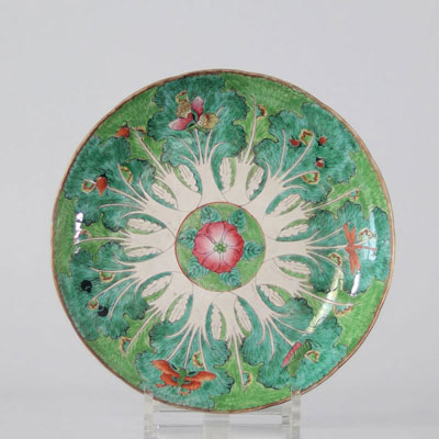 Chinese porcelain plate decorated with insect butterflies on green cabbage leaves.