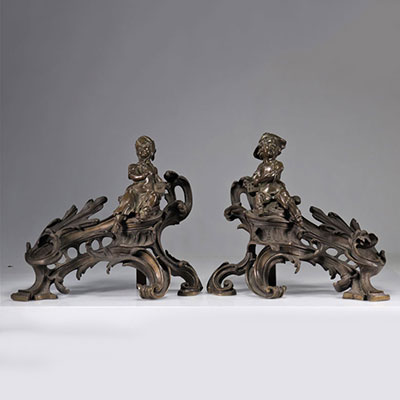 (2) Imposing pair of bronze andirons decorated with children in the Louis XV style