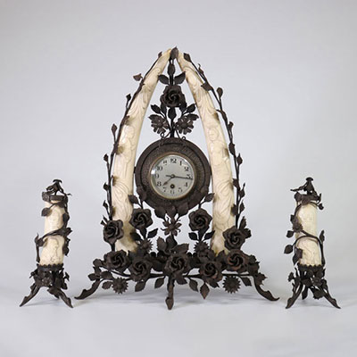 Colonial clock, in wrought iron and carved tusks circa 1920
