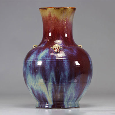 Porcelain vase covered with a red, blue and eggplant flamed glaze.