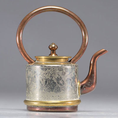 Chinese teapot decorated with immortals on a gray background