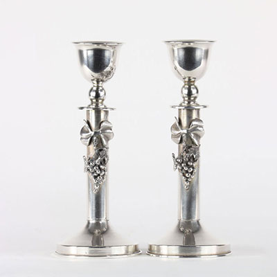 Pair of silver candlesticks decorated with bunches of grapes