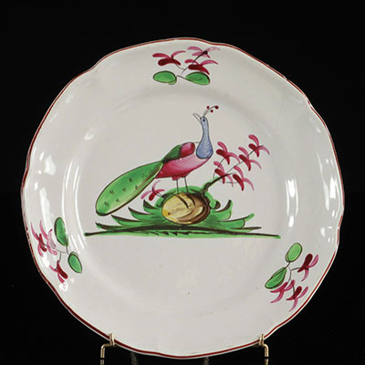 Les Islettes France Plate decorated with a peacock on a rock. 19th.