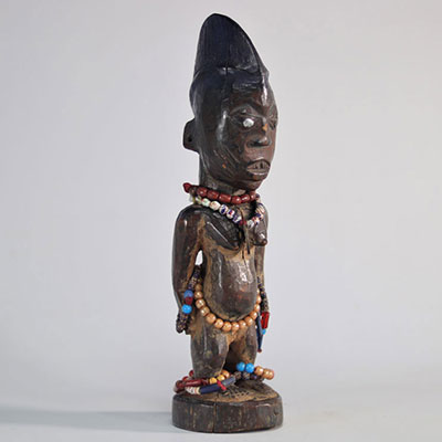 Ibeji Yoruba carved wooden statue decorated with beads