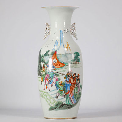 Famille rose porcelain vase decorated with figures and a landscape on a white background