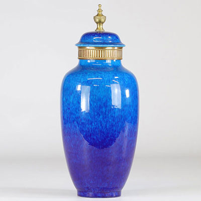 Sevres porcelain covered vase on a blue and bronze background