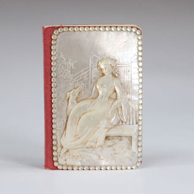 Carved mother-of-pearl ball book of a young woman with a greyhound