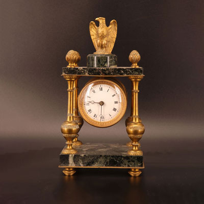 Marble and bronze clock surmounted by an eagle