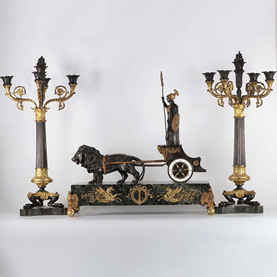 Imposing bronze trim with double patina, pendulum with chariot pulled by two lions and pair of empire candelabra